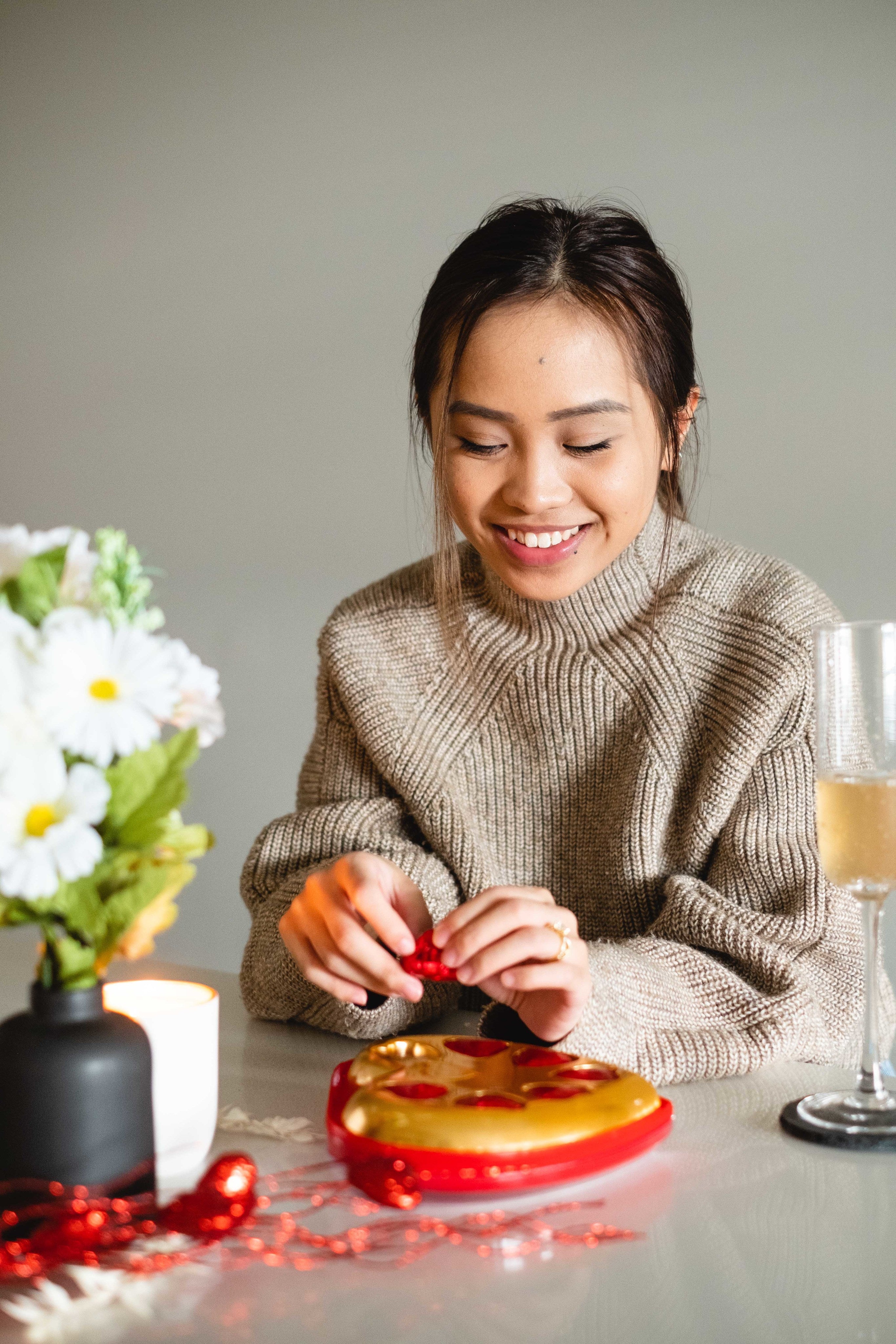 files/woman-smiles-as-she-opens-a-red-chocolate-heart.jpg
